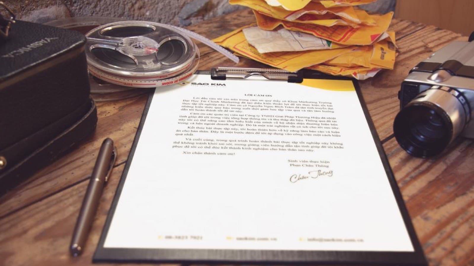 A signed paper document and fountain pen on a wooden desk