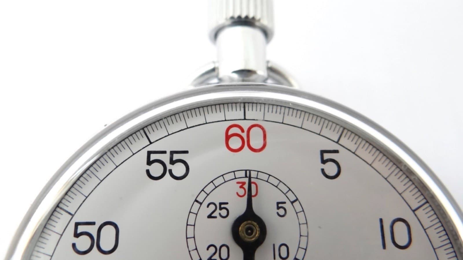 A mechanical sports stopwatch with its hand near the sixty mark