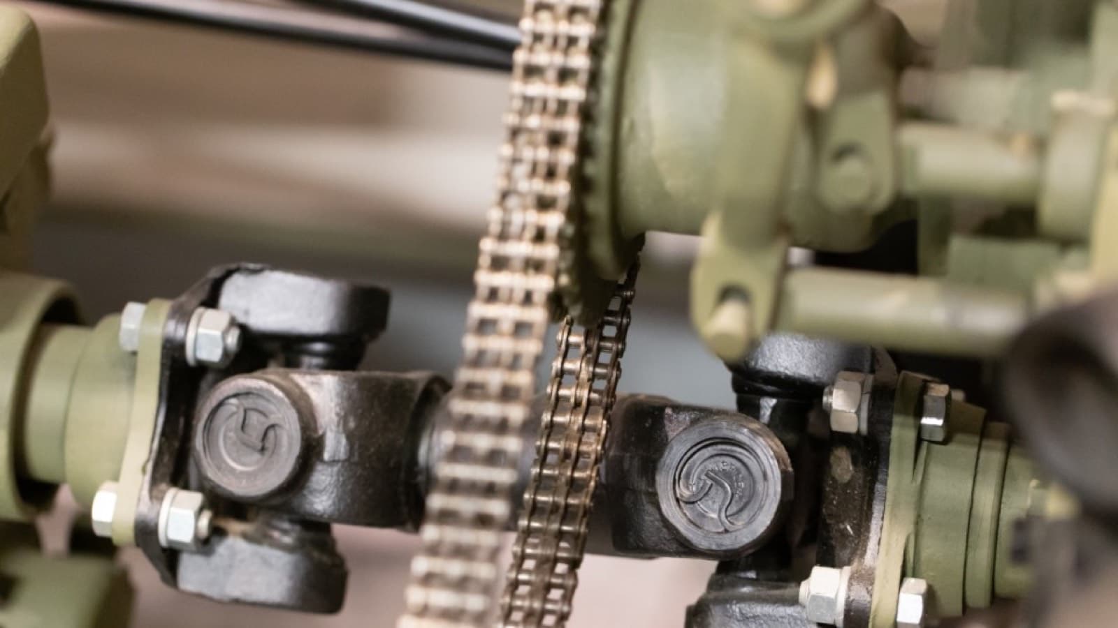 A drive chain and sprocket linking two shafts on a machine