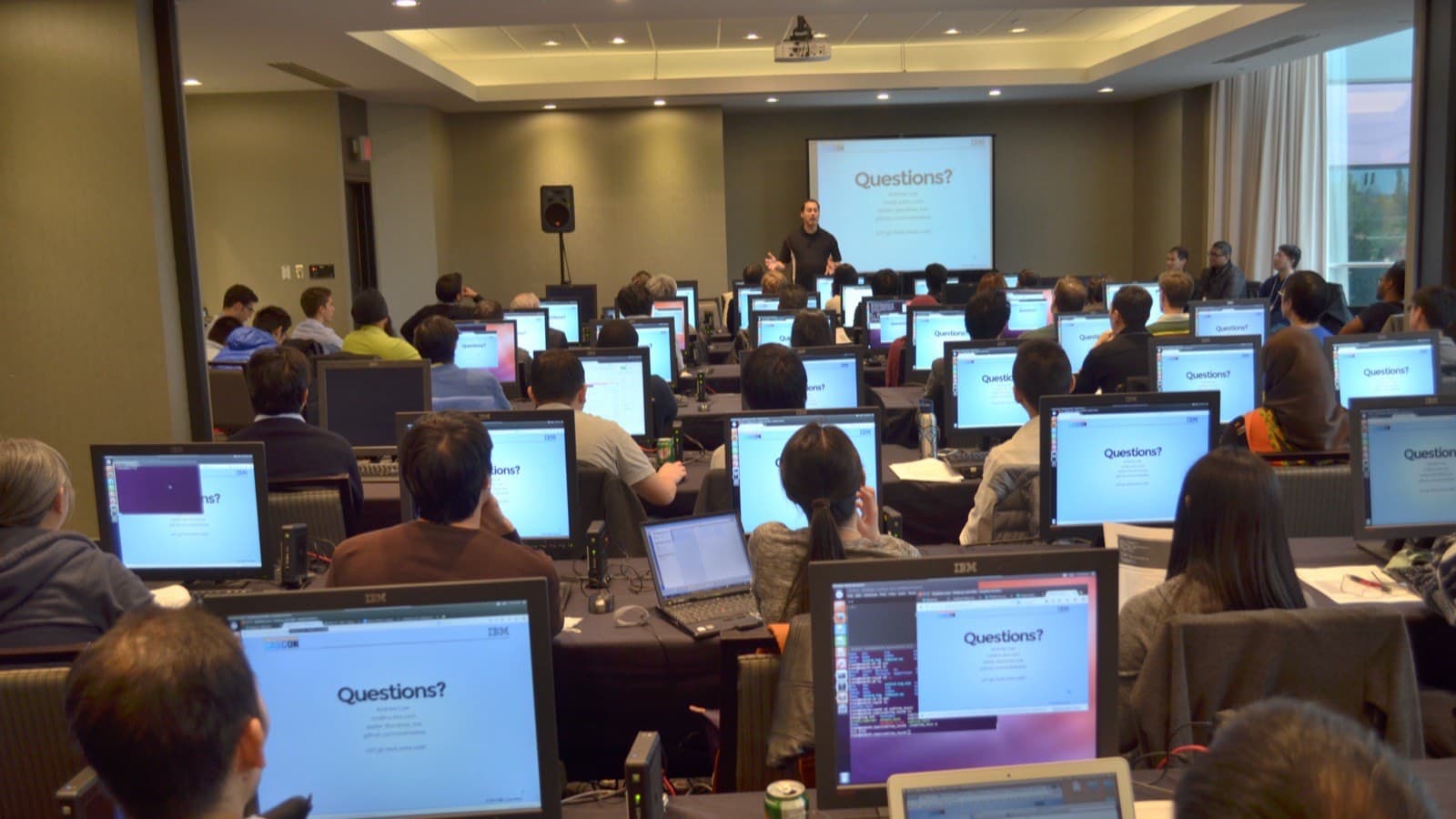 A room of people working at laptops during a computer training workshop